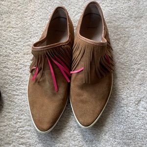 Sanuk suede brown moccasins with pink and brown ridges.